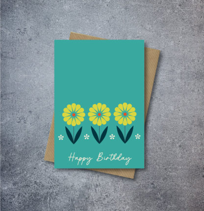 alt="Teal Mexican Flowers Card that says 'Happy Birthday' on a Kraft brown envelope"